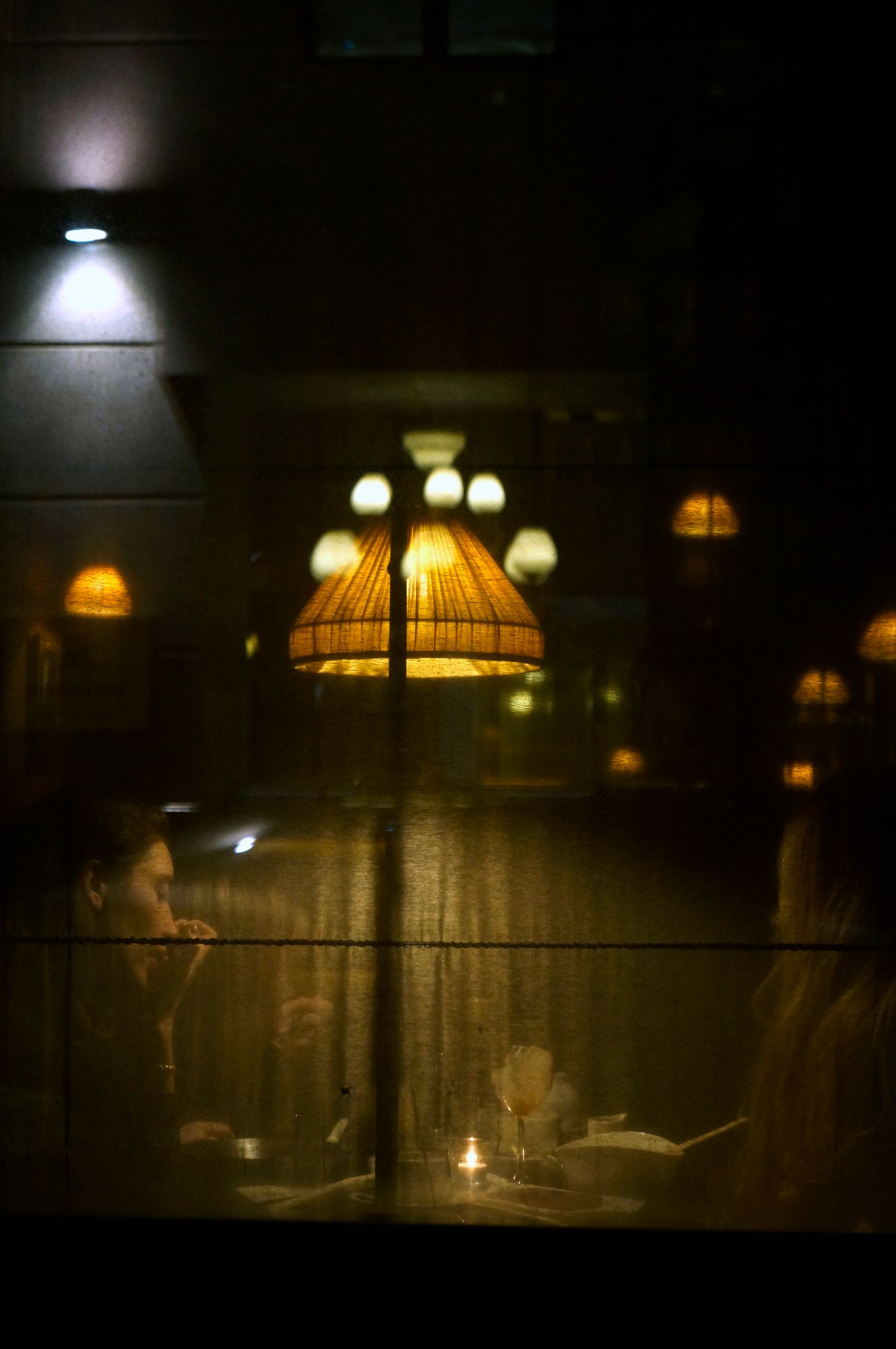Guests sit inside a warmly lit restaurant